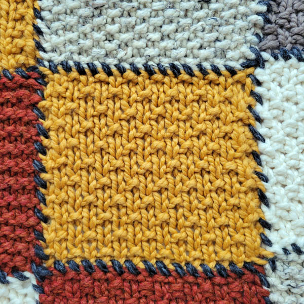 sand stitch swatch on a patchwork blanket