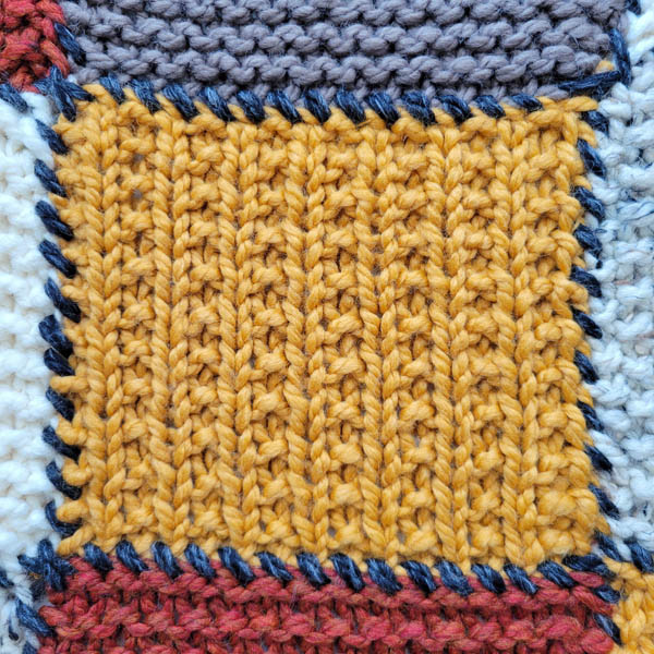 broken rib stitch swatch on a patchwork blanket