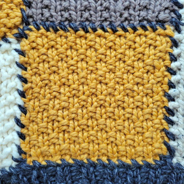 moss stitch swatch on a patchwork blanket