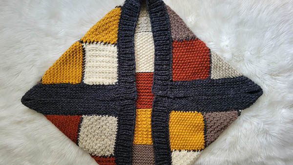 patchwork quilted shrug laying on a fur blanket
