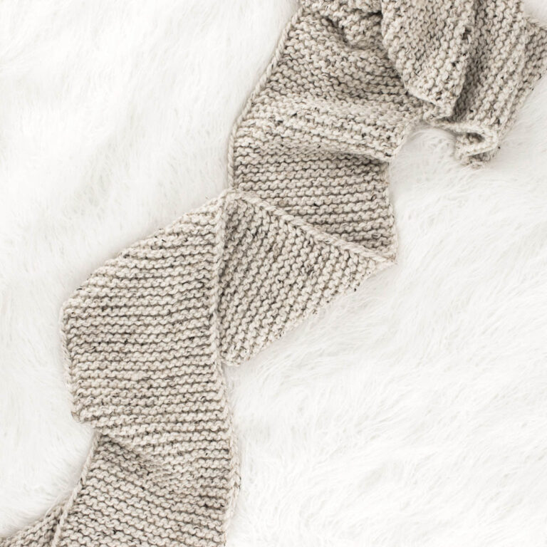 beginner scarf laying on a faux fur blanket
