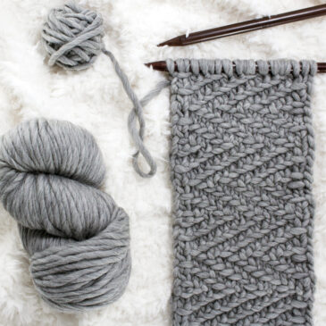 herringbone twill knit scarf on a faux fur blanket