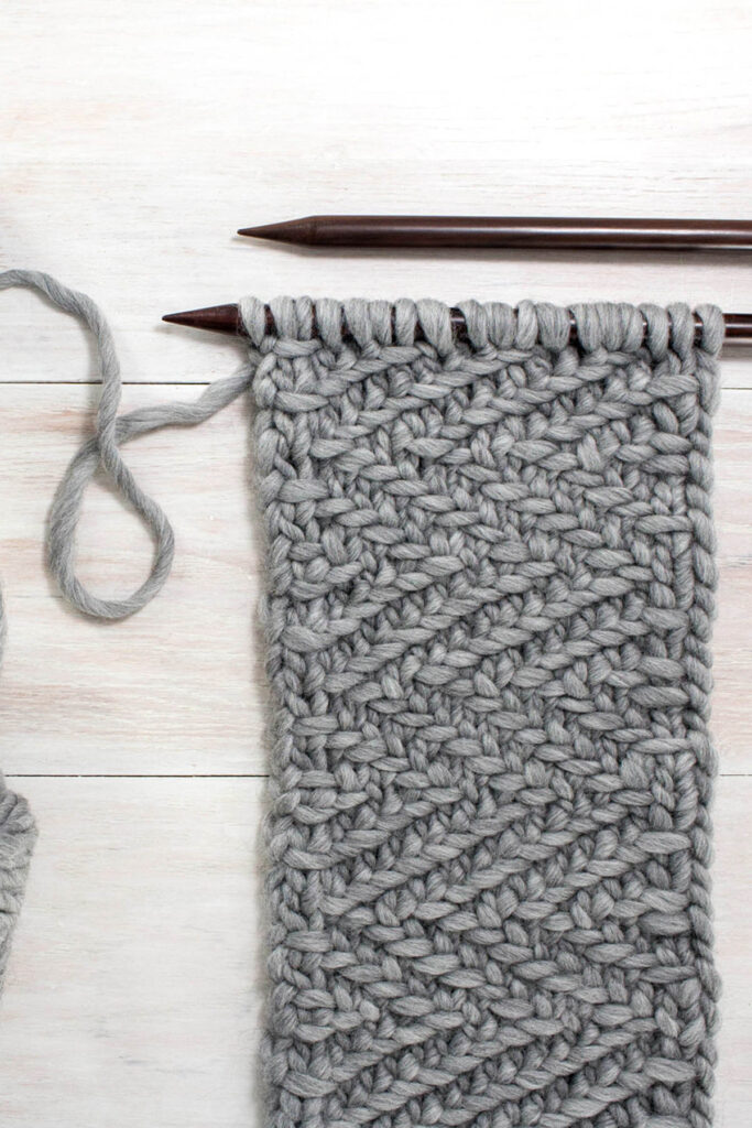 herringbone twill knit scarf on a white table