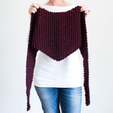chunky triangle scarf held in front of a model.