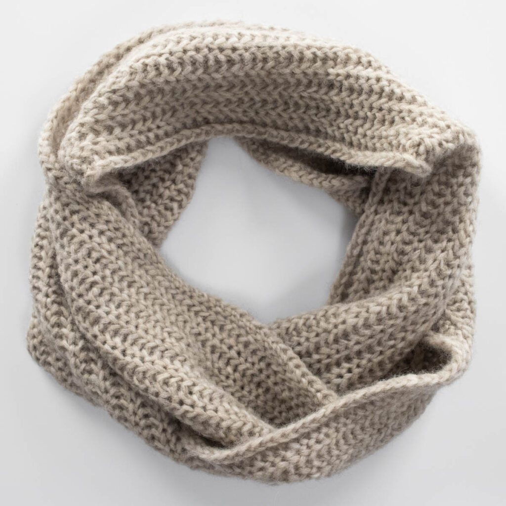lightweight knitted scarf on a table.