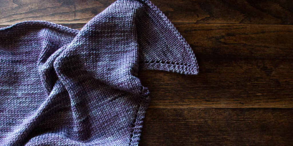 triangle scarf bandana laying on a wood table