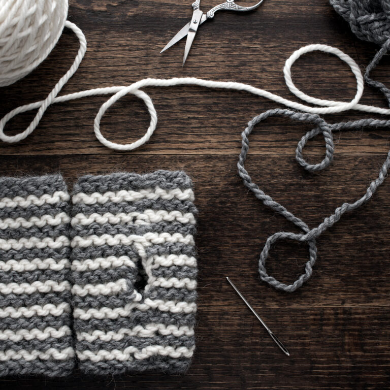 basic fingerless gloves laying on a wooden table