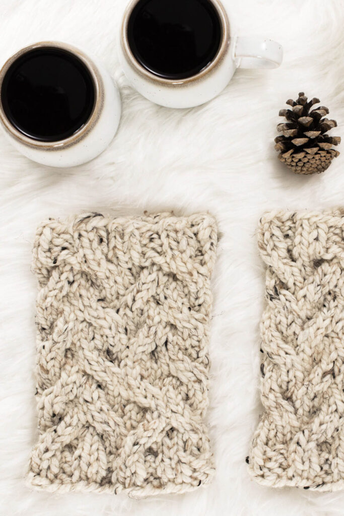 Modern Cable Knit Boot Cuffs laying on a faux fur blanket