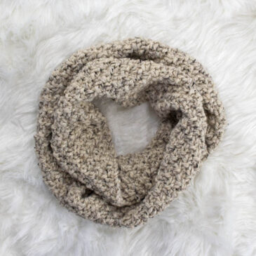 a Chunky Cowl Knit With Straight Needles laying on a faux fur blanket