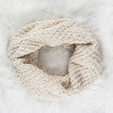 Chunky Moss Stitch Cowl laying on a faux fur blanket