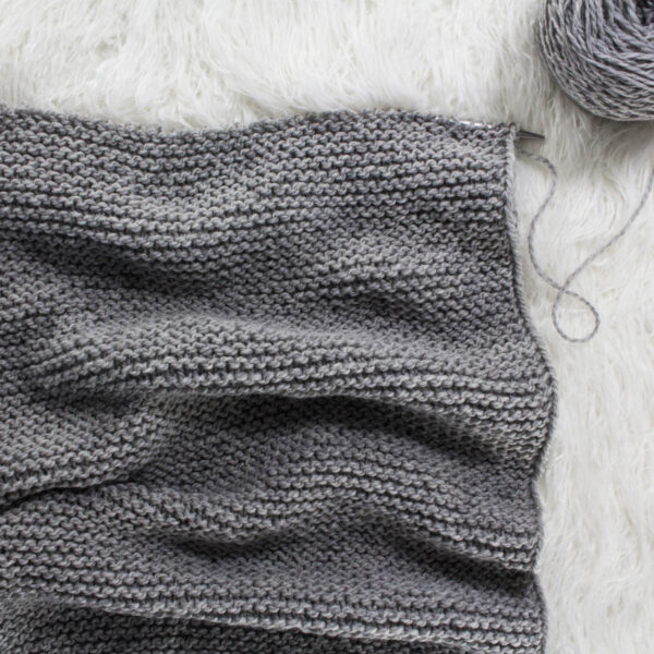 cowl knit with straight needles and on a faux fur blanket