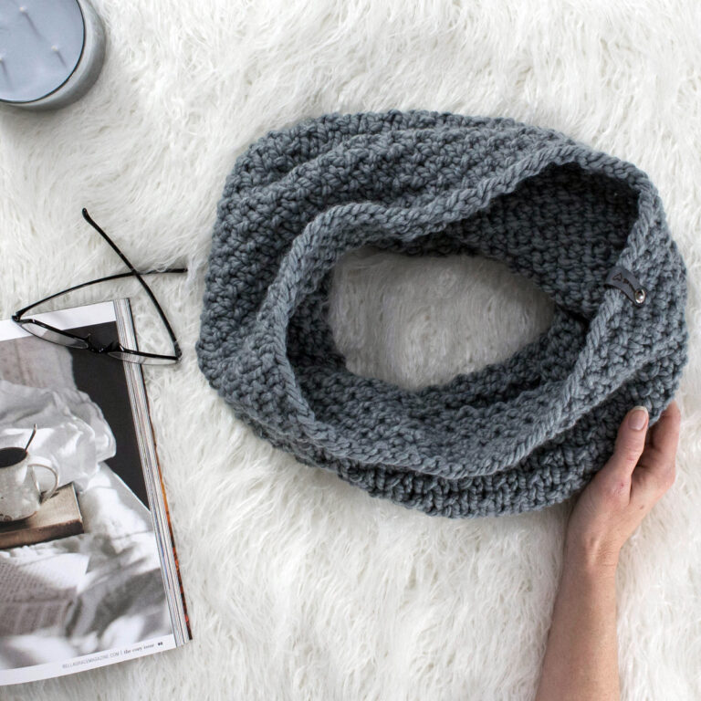 Seed Stitch Cowl laying on a faux fur blanket
