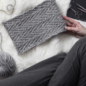 herringbone knit cowl laying on a faux fur blanket