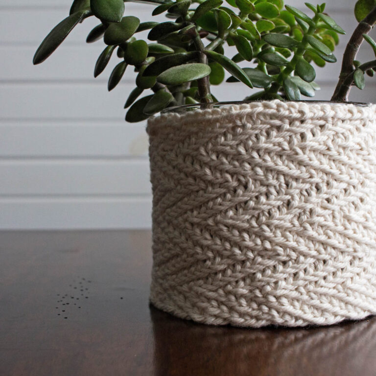pic of a herringbone stitch knitted plant pot cover