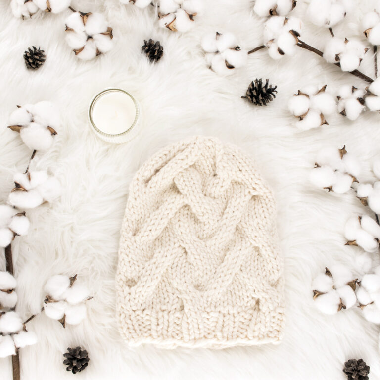 bulky knit hat displayed on faux fur blanket