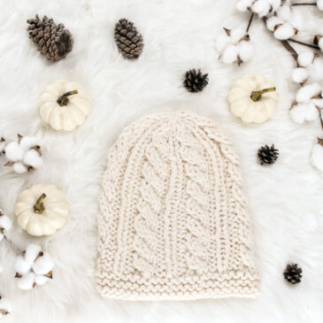 cable knit hat displayed on faux fur blanket