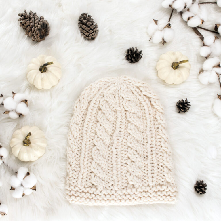 cable knit hat displayed on faux fur blanket