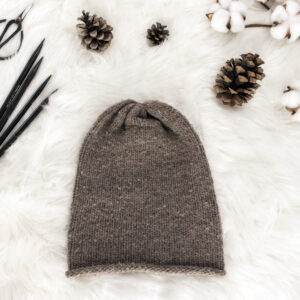 beginner stockinette stitch knit hat displayed on faux fur blanket
