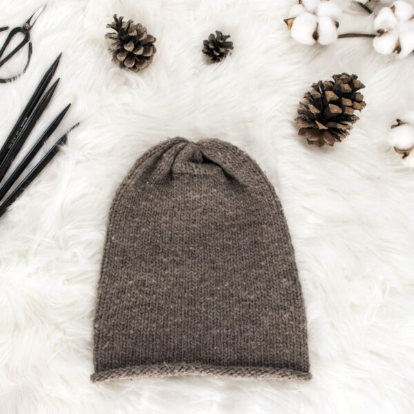 beginner stockinette stitch knit hat displayed on faux fur blanket