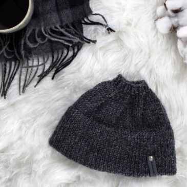 Messy Bun Hat displayed on faux fur blanket