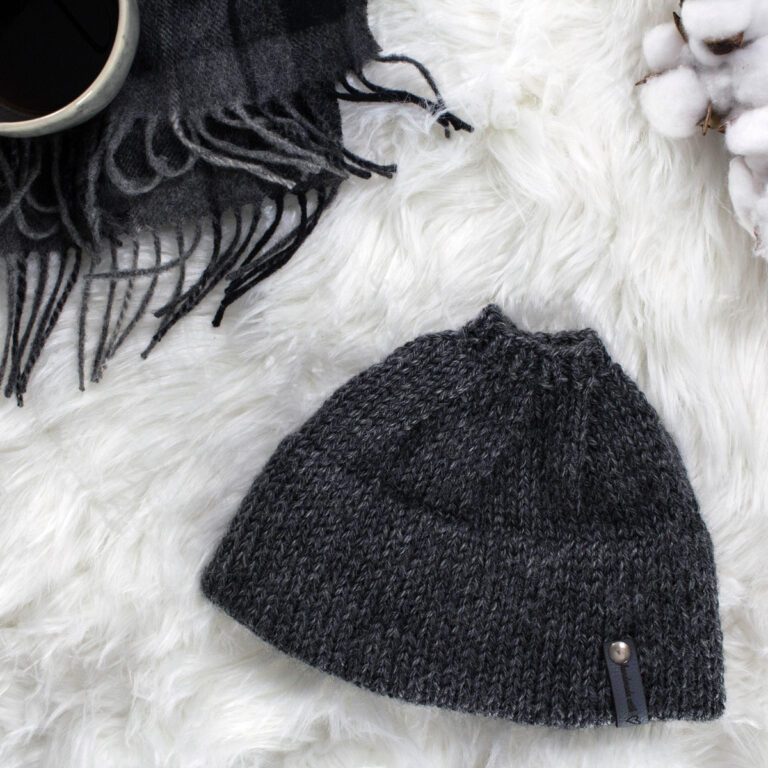 Messy Bun Hat displayed on faux fur blanket