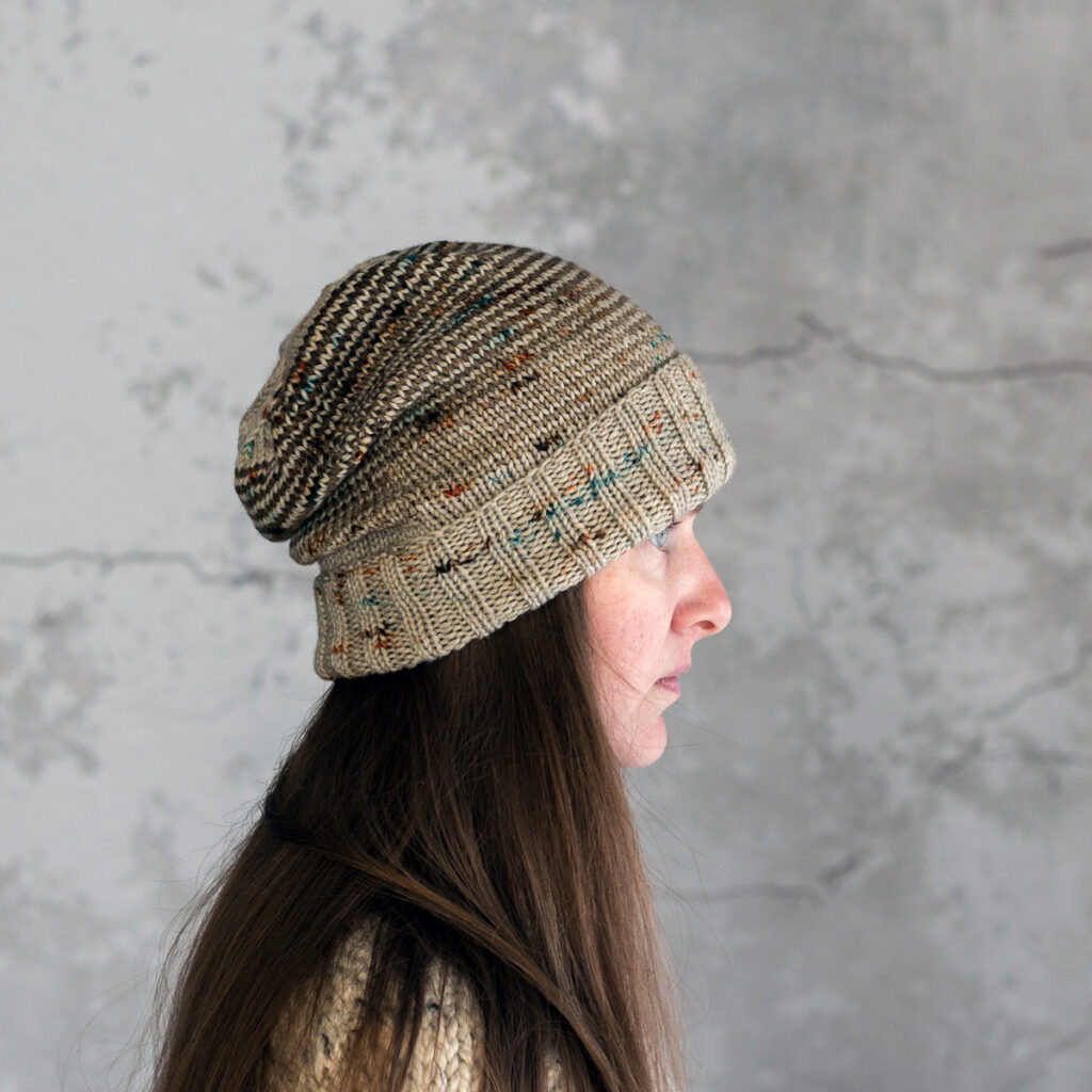 model wearing a striped knitted beanie hat