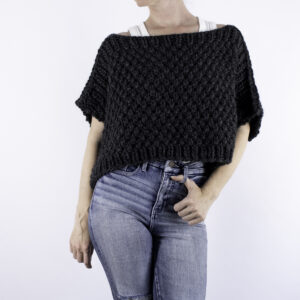 woman wearing a chunky poncho sweater
