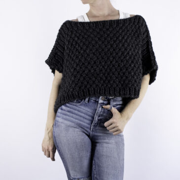 woman wearing a chunky poncho sweater