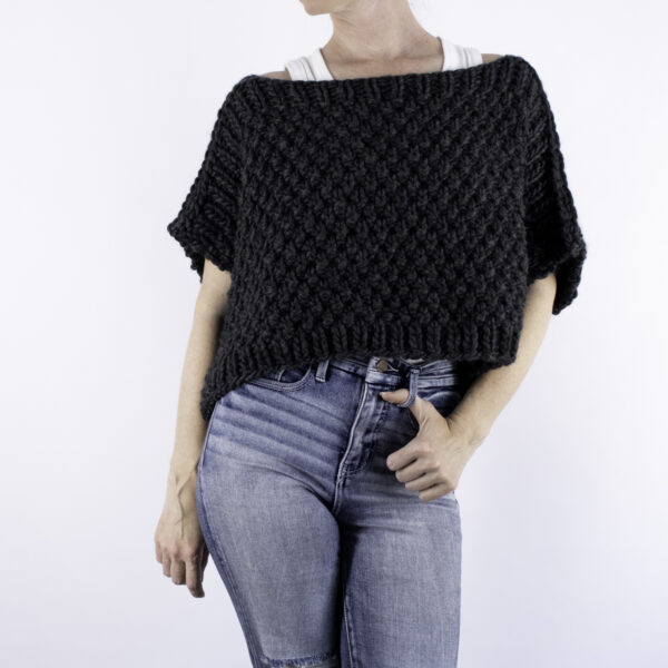 woman wearing a chunky poncho sweater