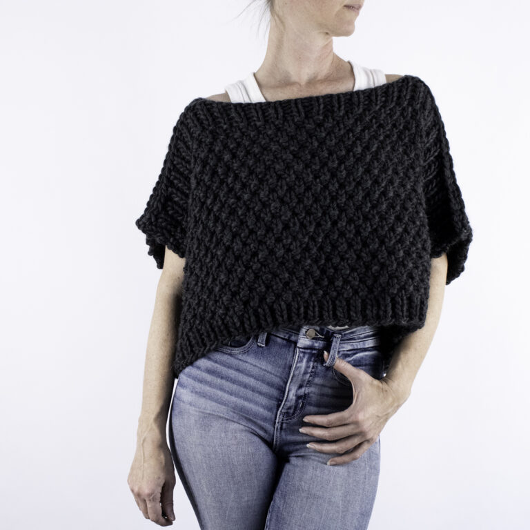 woman wearing a chunky poncho sweater