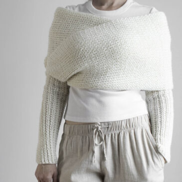 Wonderlights Sweater Scarf Side View Fit Side view of cream knit sweater scarf worn over white top with matching ribbed sleeves