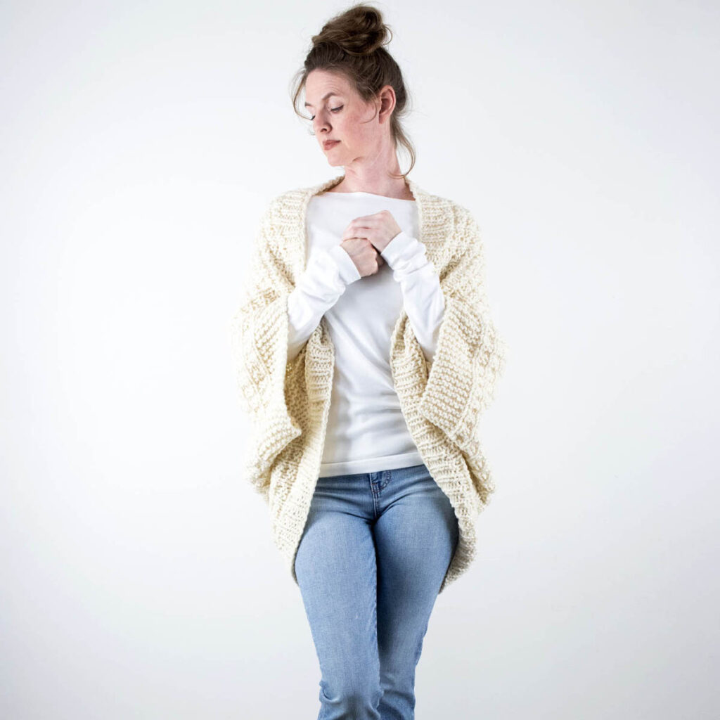 a model wearing a squishy hand knit shrug