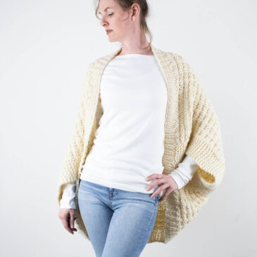 a model wearing a squishy hand knit shrug