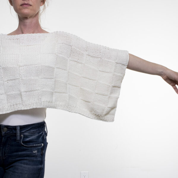 Seamless poncho knitted with DK yarn and checkerboard stitch for a lightweight summer accessory