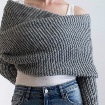 model wrapped up in a gray sweater scarf knit in garter stitch