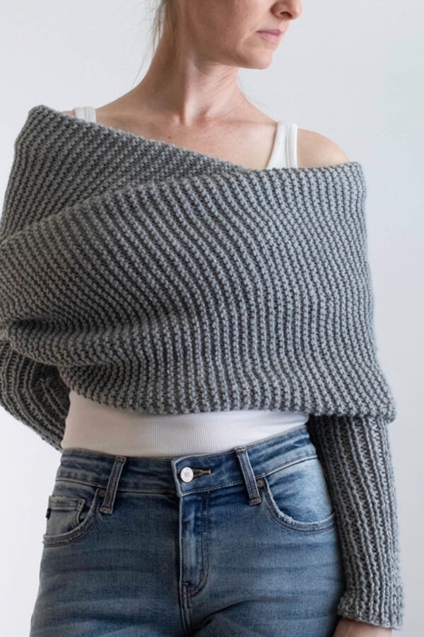 model wrapped up in a gray sweater scarf knit in garter stitch