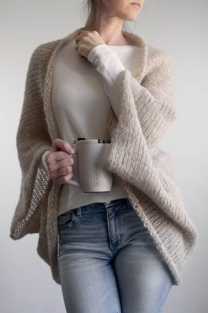 Full length view of the Halo Shrug knitting pattern, relaxed boyfriend fit in light beige