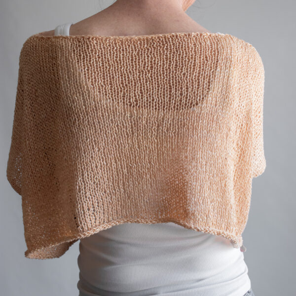 a woman wearing a peach linen knit tee from the front, back, and sides. The boxy cropped top has short sleeves and a wide neckline.