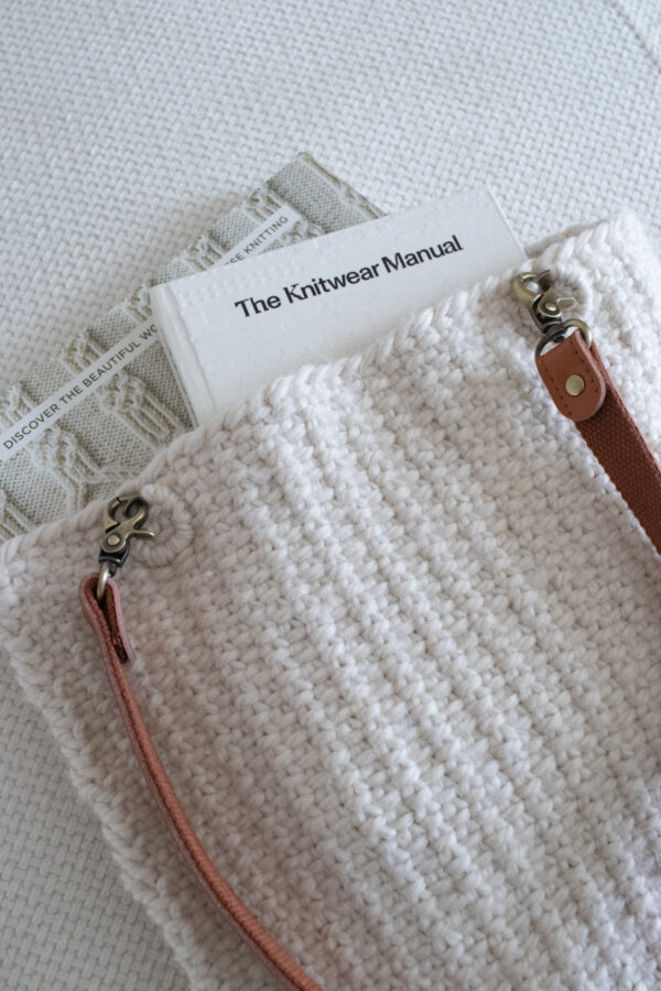 Pic of a linen stitch tote bag with books peeking out of the top