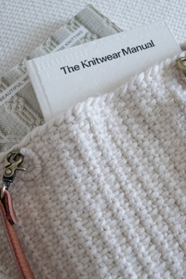 Pic of a linen stitch tote bag with books peeking out of the top