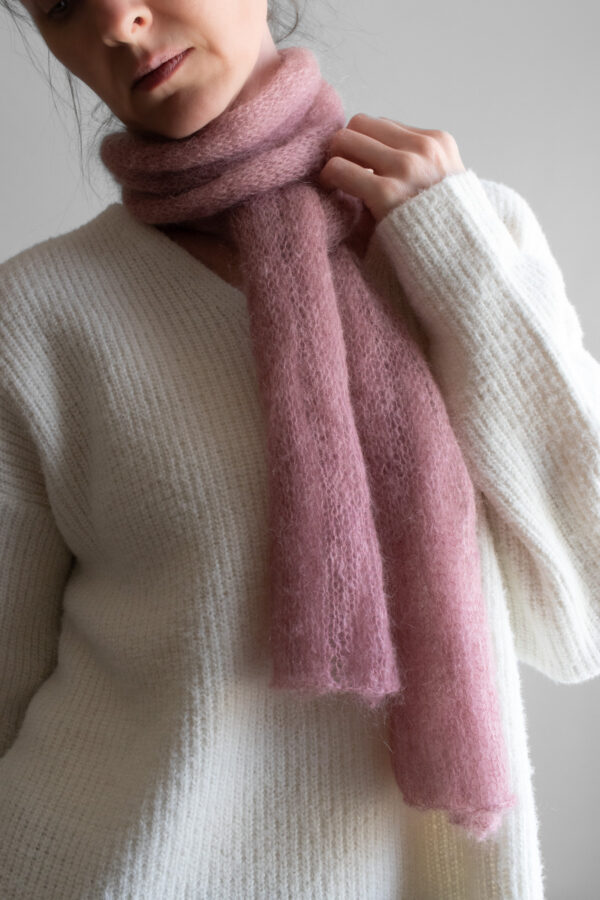 Simple, one skein soft pink lightweight knit scarf worn by a model