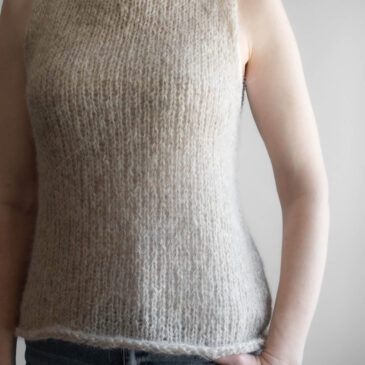 Fall Tank Top Sweater Knitting Pattern A model wearing a handknitted brushed alpaca tank top in oatmeal, shown from the front angle.